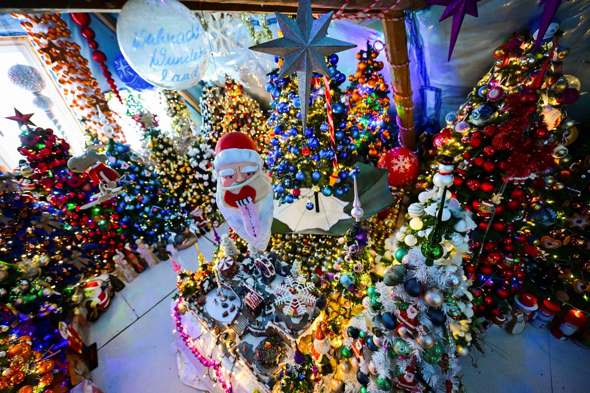 A family is breaking their own record for the most Christmas trees in their home