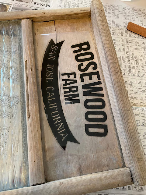 Photo of a farmhouse decor transfer being added to a washboard.