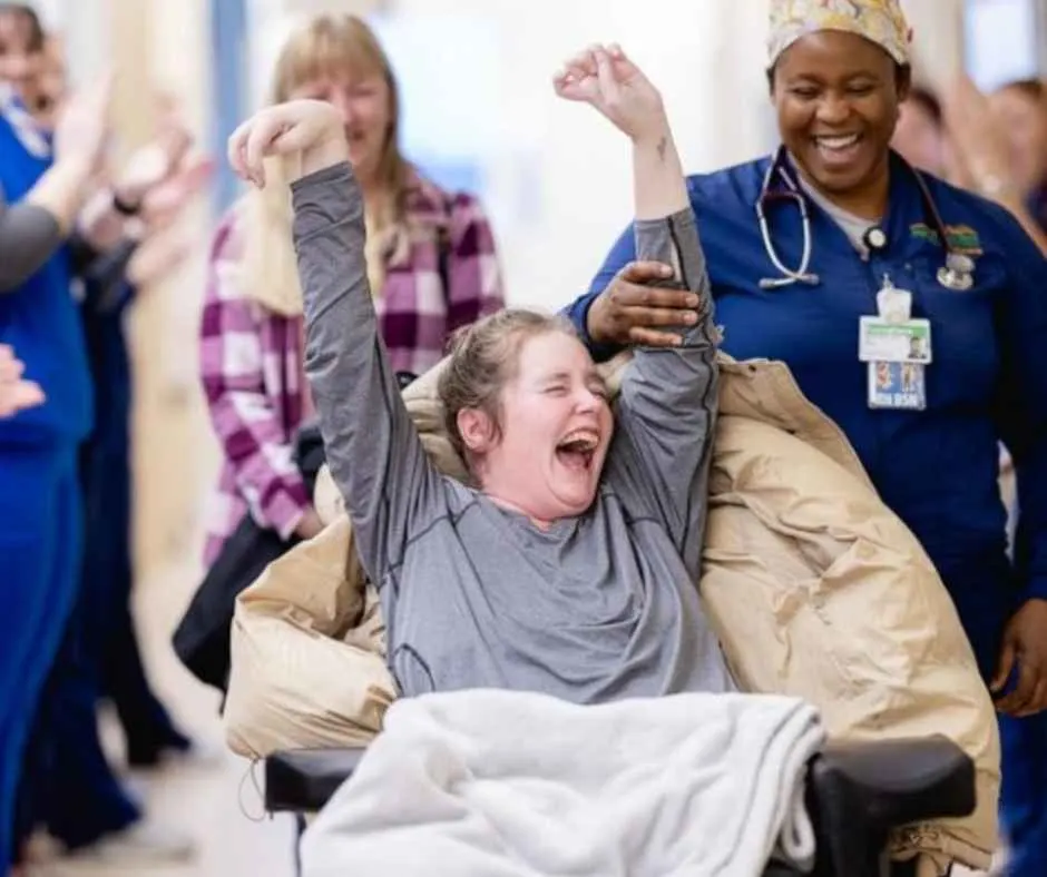 Jennifer Flewellen raising her hands as a winner during her recovery.