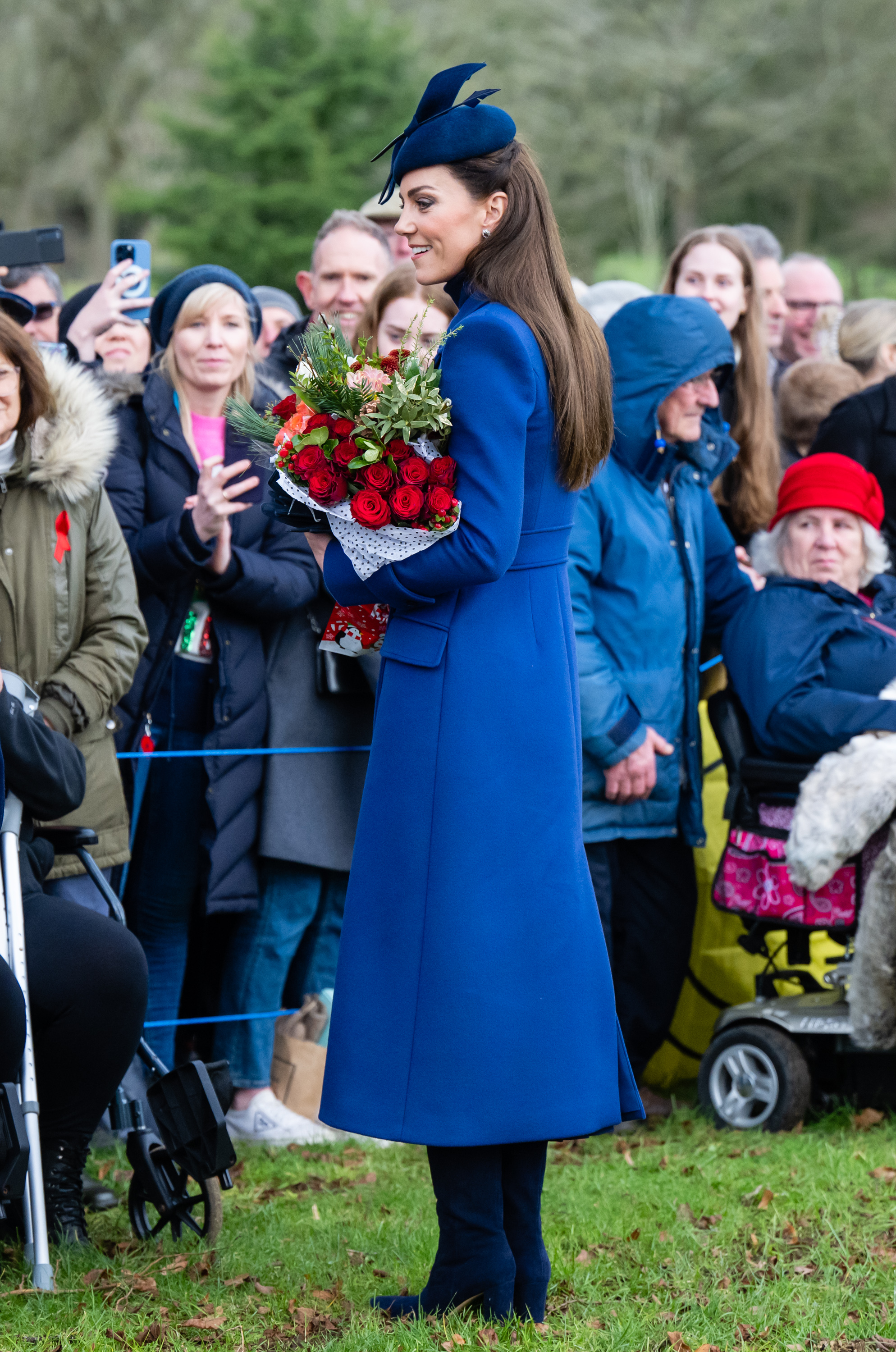 Catherine, Princess of Wales greeting the crowd as she carried a bouquet of roses on the way to the Christmas morning service at St. Mary Magdalene Church on December 25, 2023 in Sandringham, Norfolk | Source: Getty Images