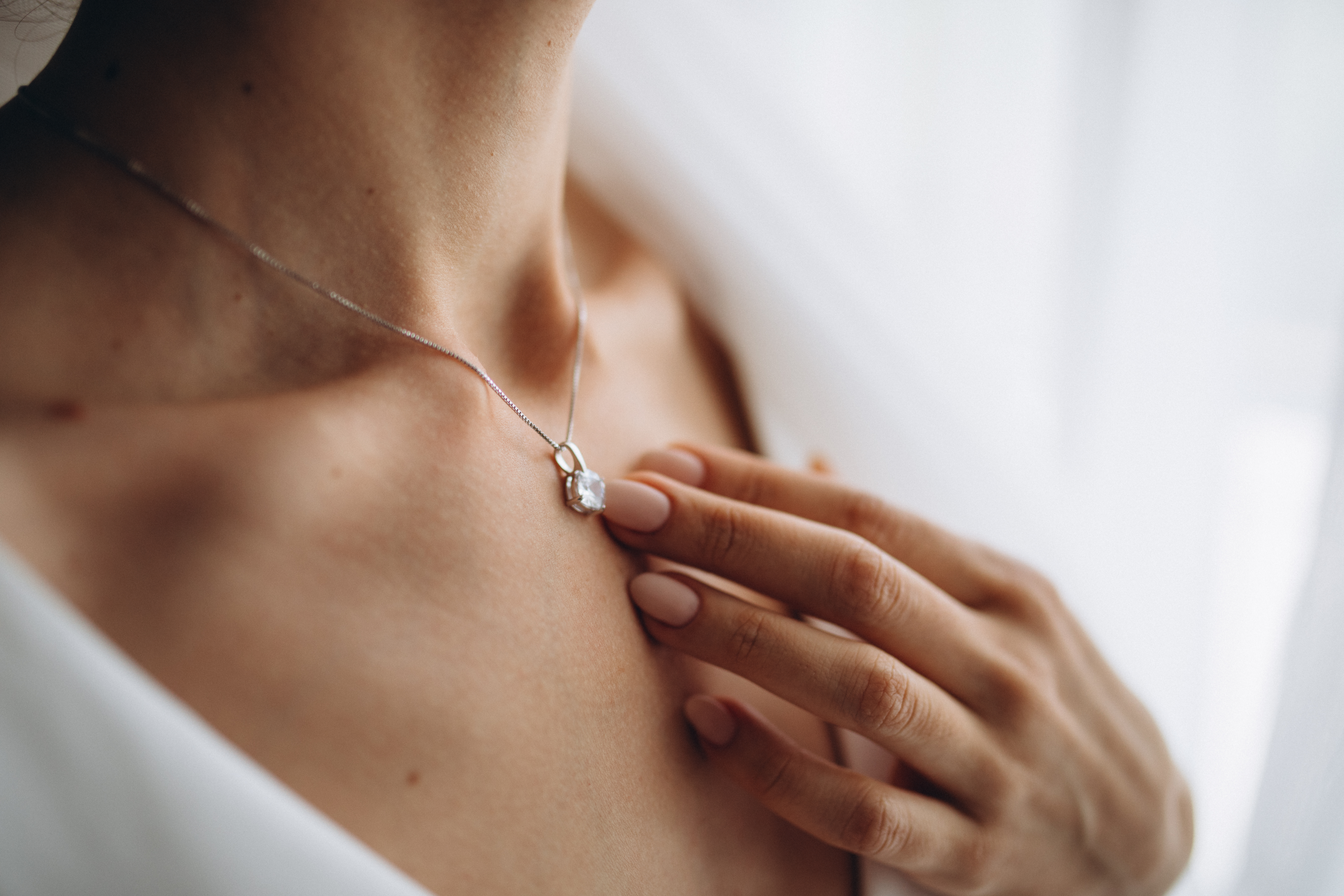 A young woman in a shiny diamond pendant | Source: Shutterstock