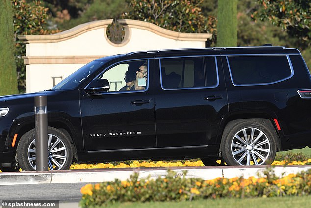 SUVs carrying mourners are seen on Friday outside the cemetery