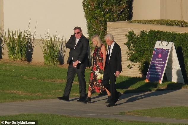 Friends and family of Perry leave the site after the service
