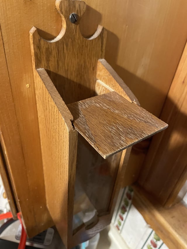 r/whatisthisthing - What is this thing screwed into the outside of the cabinet to the left of my sink. Wood and hard plastic, sliding door on the top and two piece of velcro on the inside of the bottom. House was built in 1930 but had a major reno in the 1970s.