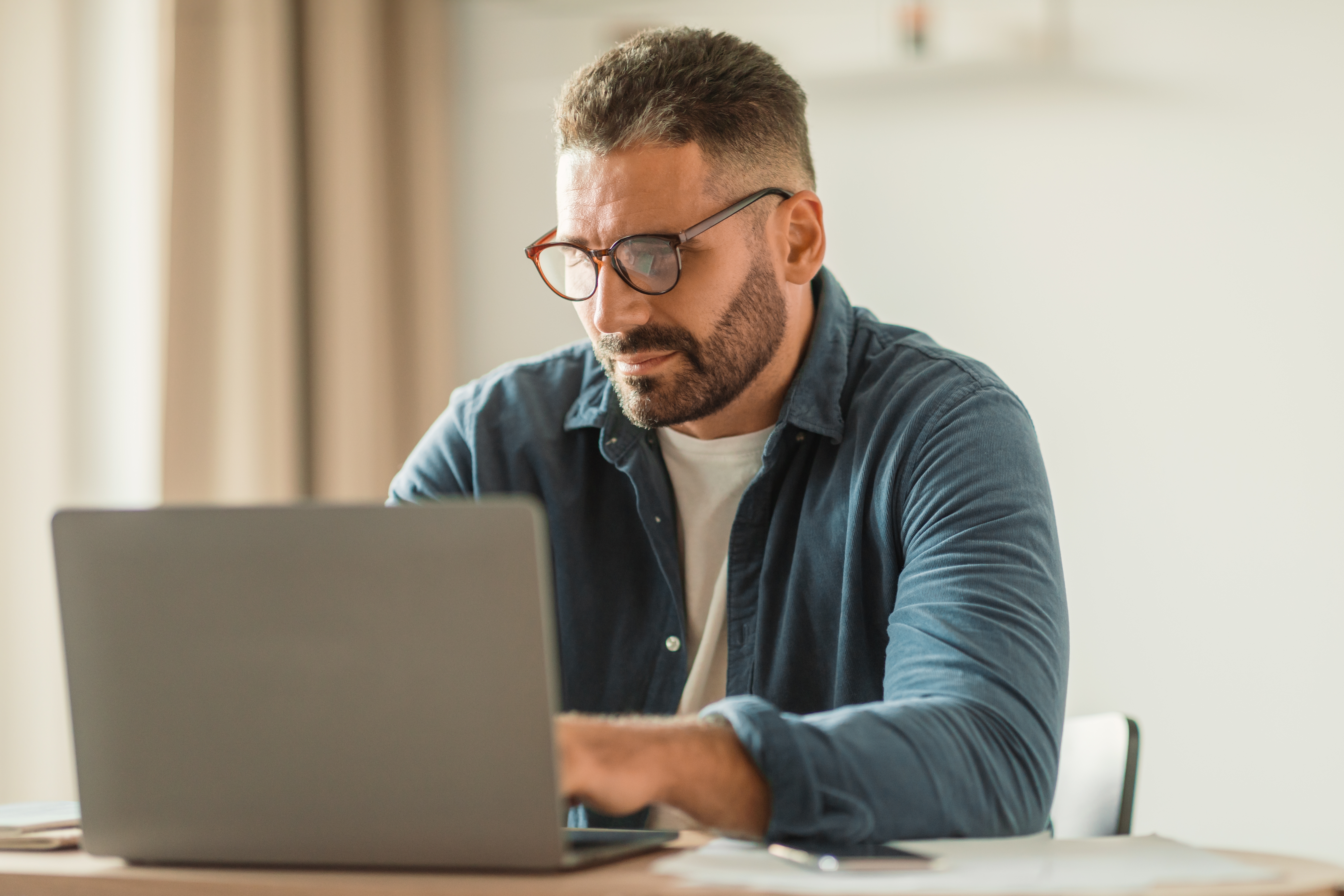 Man typing in his computer | Source: Shutterstock