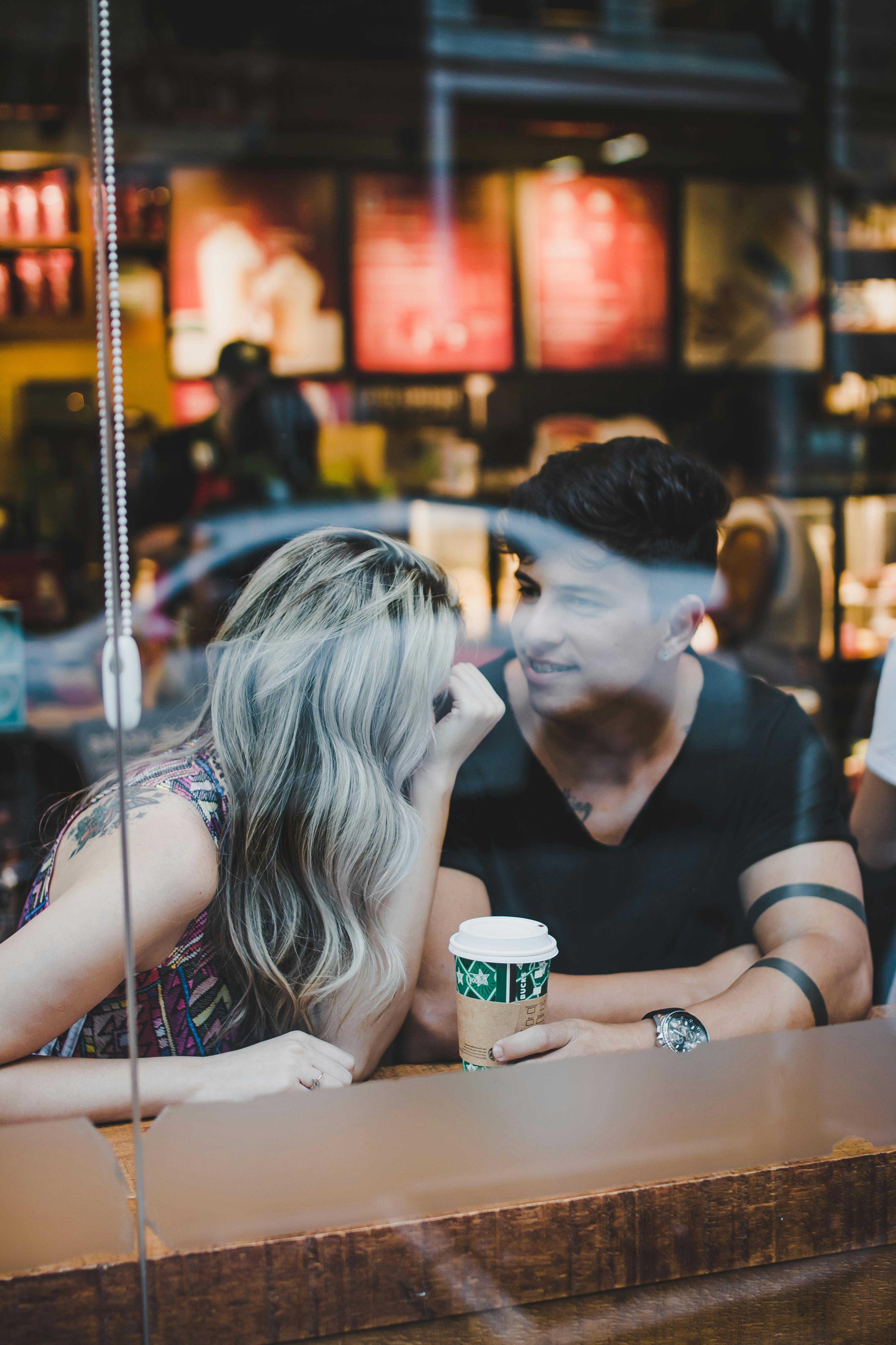 A happy couple having beverages at a shopping center | Source: Pexels